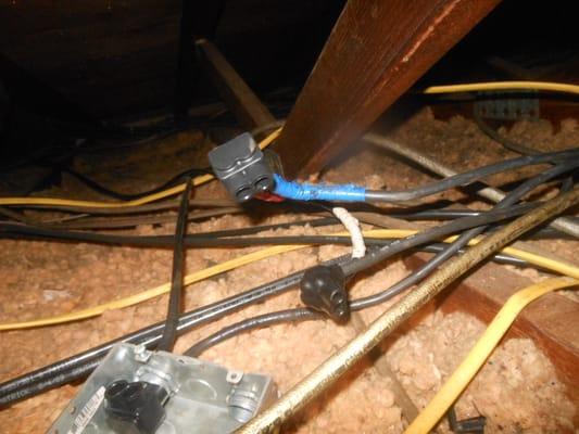 A very hazardous electrical system found in the attic of a apartment building.