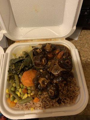 Oxtail with rice and beans green's cabbage and mixed vegetables