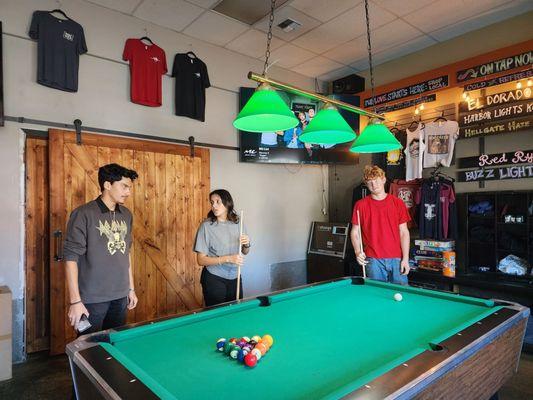 Pool table and merch area.