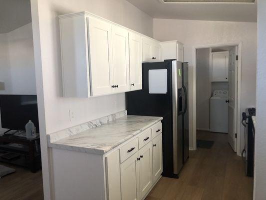 Kitchen counter, cabinets, and flooring