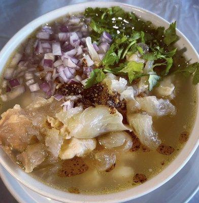 Our white menudo with fresh onions, cilantro and our homemade chili sauce