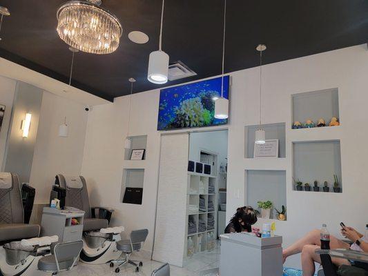 Pedicure section of salon with video of rltropical fish and signs requesting quiet to allow maximum relaxation