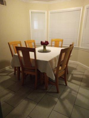 Shared dinner table and chairs, where breakfast, lunch, and dinner is served.