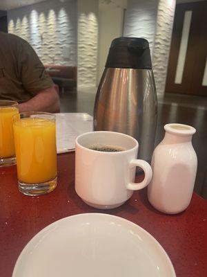 Coffee carafe left at table & creamer