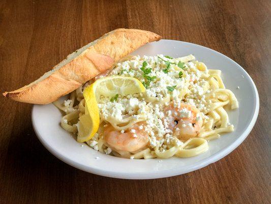 Shrimp Scampi: shrimp baked in garlic lemon butter and white wine, tossed with handmade linguine and topped with feta cheese.