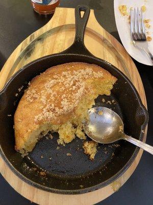 Cornbread served in a hot cast iron skillet.