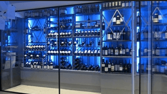 Sleek design and blue lighting update a wine cellar to match this modern abode