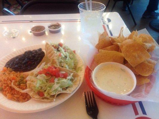 Two taco plate (one puffy) with white queso and chips!