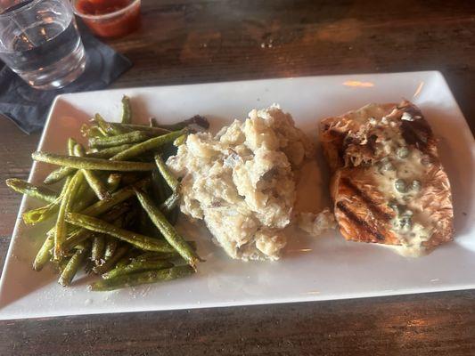 Salmon with mashed potatoes and fried green beans.