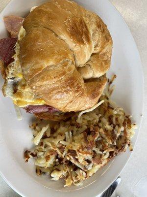 Ham, cheese and egg croissant and hash browns