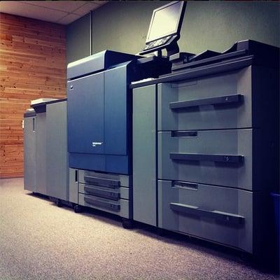 Our Konica C8000 is a beast! Full color prints upto 130# 13x19 stock.