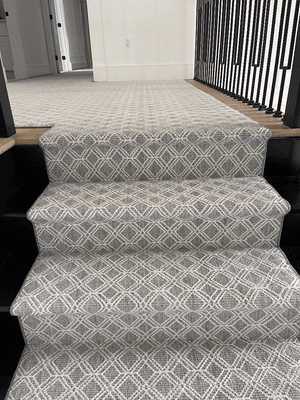 Water fall step and landing runner with pattern carpet designed and installed by Aladdin Carpet & Floors