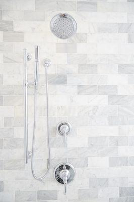 Marble tile walls in this master bath renovation project perfects the project.