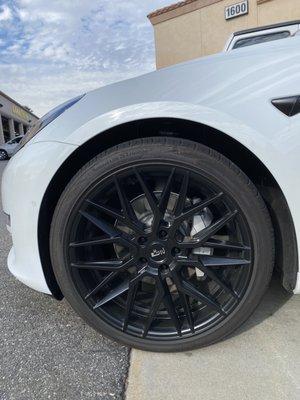 Before and after red calipers installed on my new Tesla.