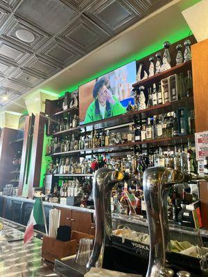 Bar seating with a couple of big TVs