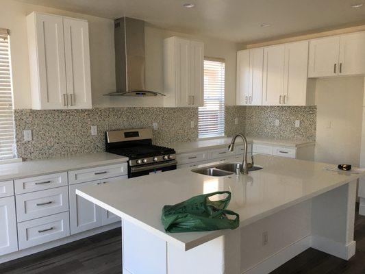 Custom kitchen cabinet instalation with Carrera marble countertops.