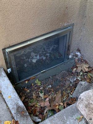 Brand new crawlspace gate w/ a fresh layer of cement to seal-up the bottom!