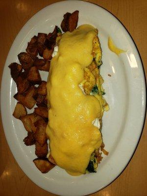 Crab, shrimp, spinach, & feta omelet (semi-custom) topped with hollandaise sauce with oven-roasted potatoes.  So yummy!!!