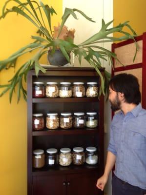 Wylie Huey-owner & acupunctrist in front of his herb collection