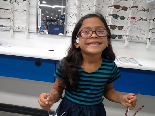 one of our happy patients choosing her first pair of glasses =)