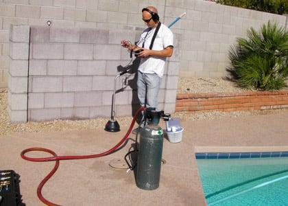 Sonically pinpointing an underground pool leak.