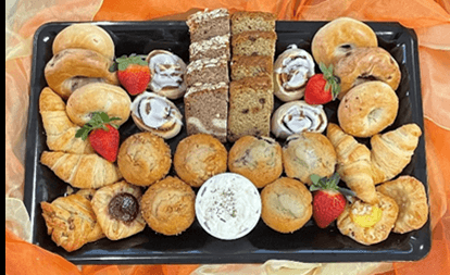 Continental Breakfast Tray with muffins, Danish, croissants, cinnamon rolls , bagels with cream cheese and coffee cake slices