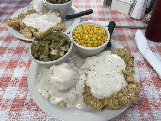 Chicken fried steaks, green beans and corn.