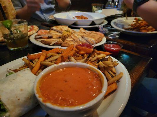 Caesar wrap, fries, tomato bisque soup, pita and hummus, and sweet potato fries!