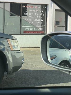 Toyota on Western hours of operation advertised in the window.