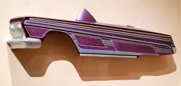 Another exhibit in the low rider section. A part of a sparkling purple car.