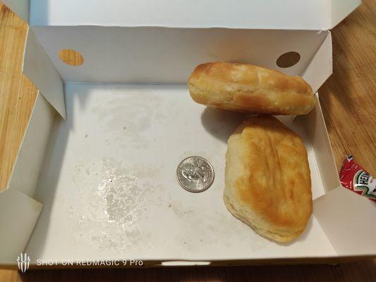 their biscuits with a side view to see how thin and small they are, quarter for size reference