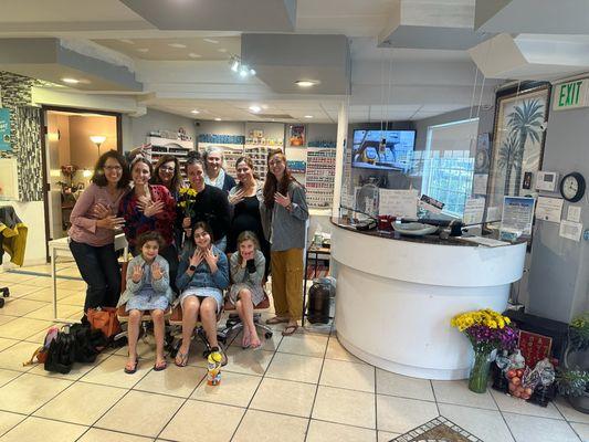 A happy wedding party group showing off their manicures and pedicures.