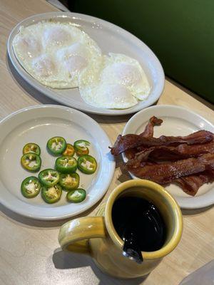 Eggs, bacon and jalapeños with black coffee