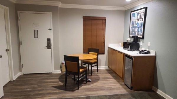 Dining area with microwave, mini fridge and coffee maker.