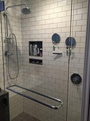 3-panel 3/8" pivoting walk-in shower assembly over tiled pony wall, with twin chrome towel bars.