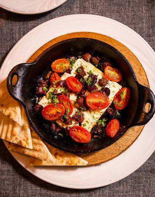 Baked feta tossed in evoo with cherry tomatoes and kalamata olives , drizzled honey