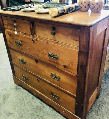 Tongue and groove solid wood (oak?) chest of drawers with antique brass hardware.