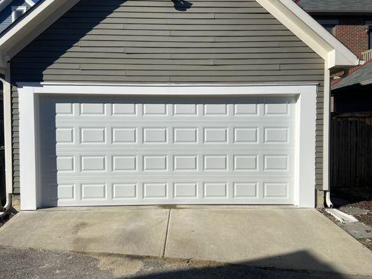 Converting two single car garage doors into one large garage door.