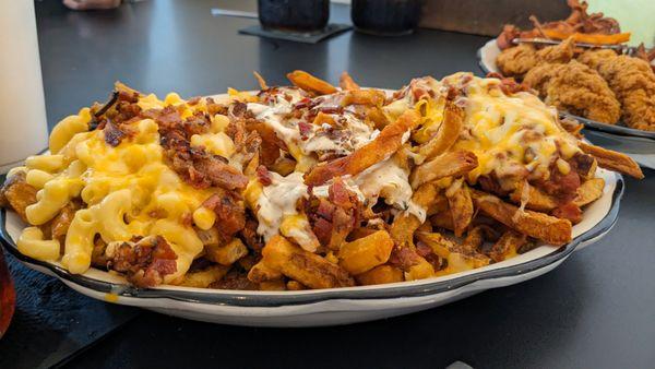 Trio Flight of Fries - Mac & Cheese; Bacon Cheddar Ranch; Chili Cheese Fries | There's some non-exciting chicken tenders in the background.