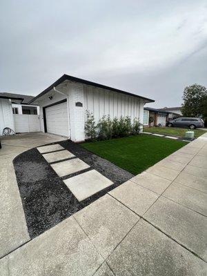 Concrete walk way, artificial turf and garden bed