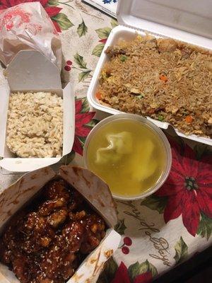 Clockwise from top right: house fried rice, wonton soup, sesame chicken, brown rice