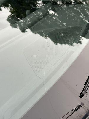 Existing damage to window of rental car that was not visible inside the rental parking structure location