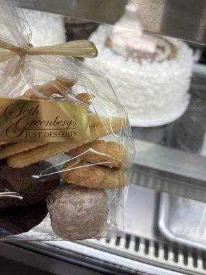 Selected cookies with coconut and cream cake in background