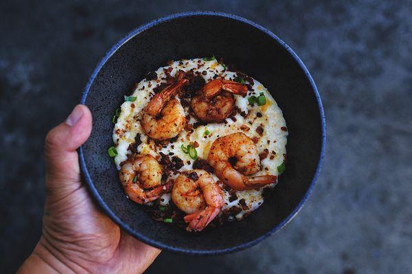 Tazo seasoned shrimp with cheesy grits, topped with green onion and bacon pieces