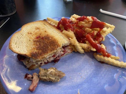 Thanksgiving Dinner special with turkey, stuffing, whole cranberry sauce, gravy with French fries.