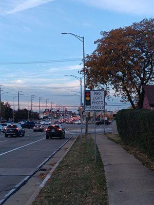 This photo here shows how the photo enforced sign is 7 to 8 feet high as opposed to being eye level, where you can see it at night.