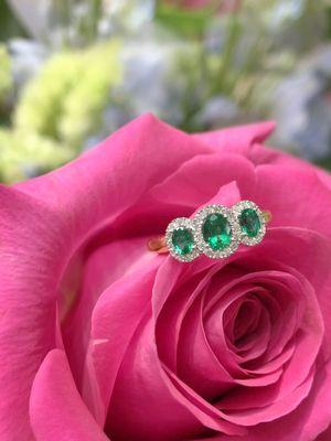 Three stone emerald ring with diamond accents