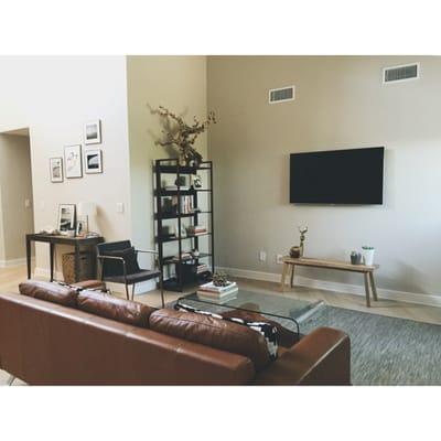 Electrical outlet was installed on the wall to the left of the wall at a 90 degree angle with the TV.  It's hidden behind the bookshelf.