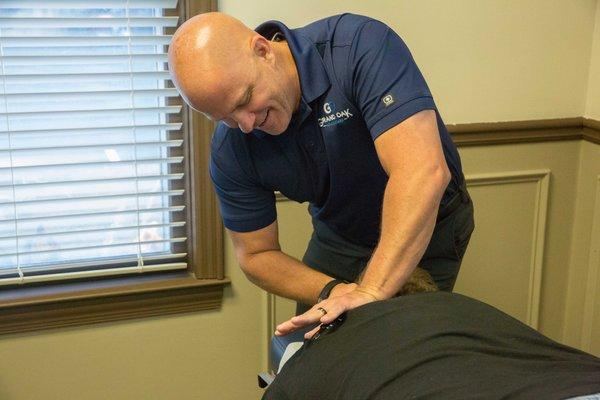 Dr. Giles performing a chiropractic adjustment.