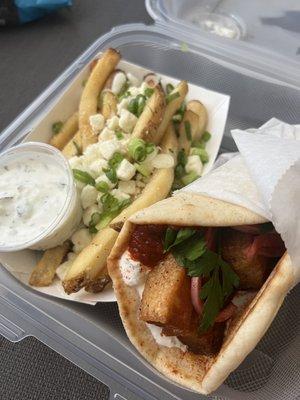 Pork belly gyro with greek-street tzatziki, tomato jam, parsley, pickled red onions, and paprika. Side of Greek fries with tzatziki sauce.